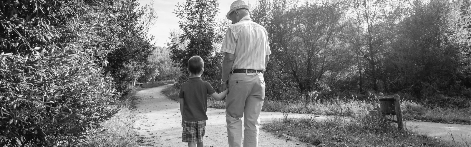 elderly man walking with grandson